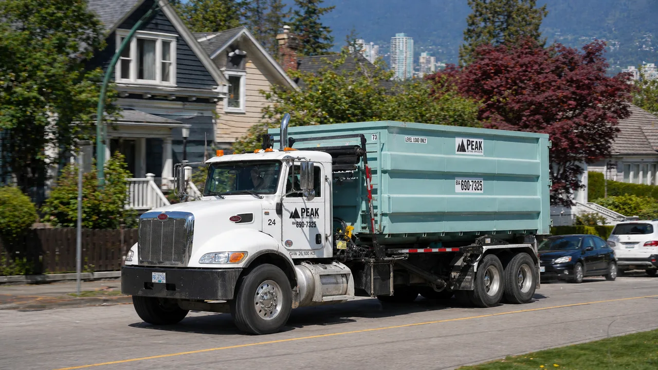 Bin rental truck carrying a residential bin for home delivery across the service area