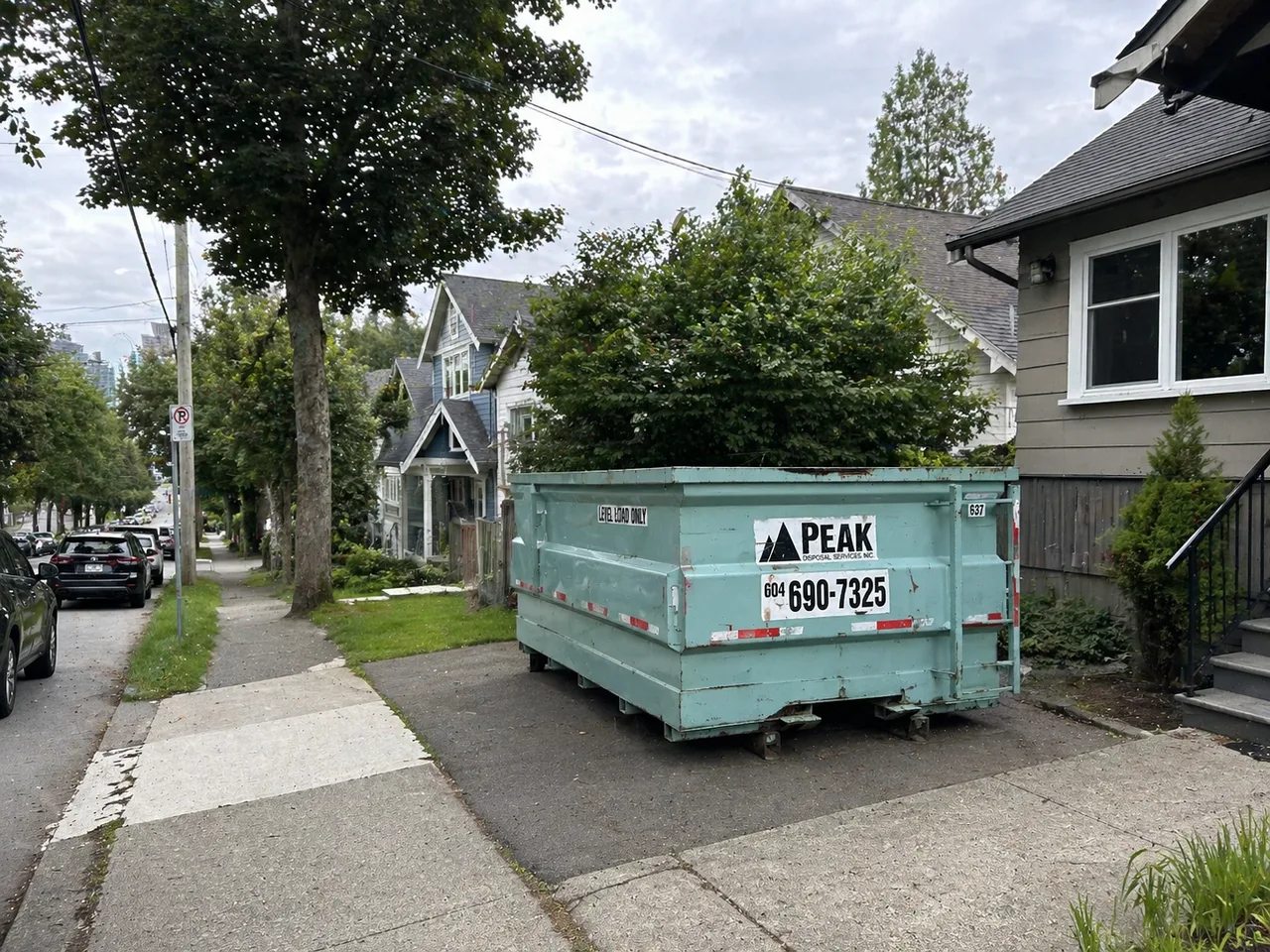 Residential bin placed on a narrow Vancouver driveway without blocking the sidewalk