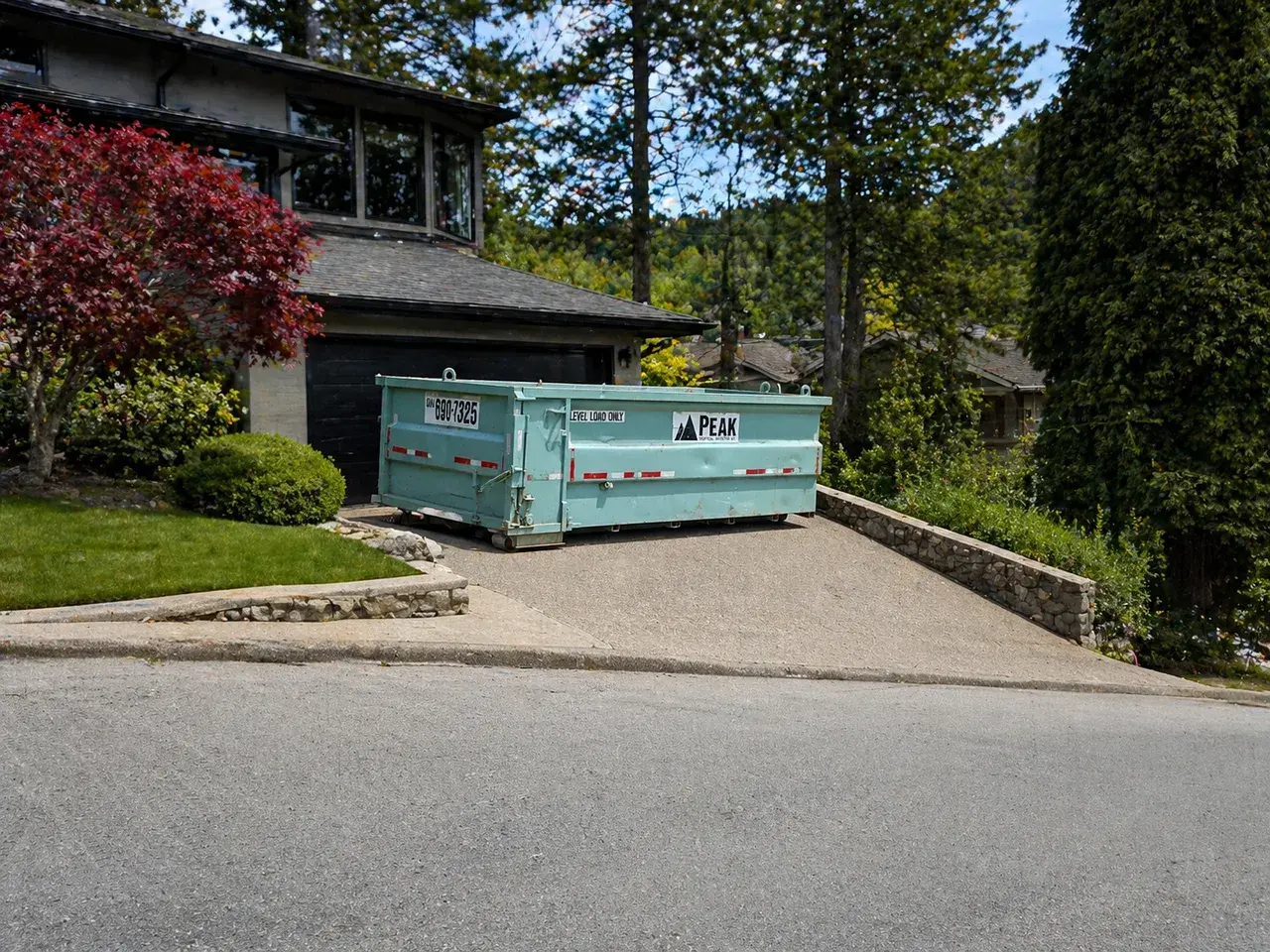 Residential bin placed on a sloped West Vancouver driveway